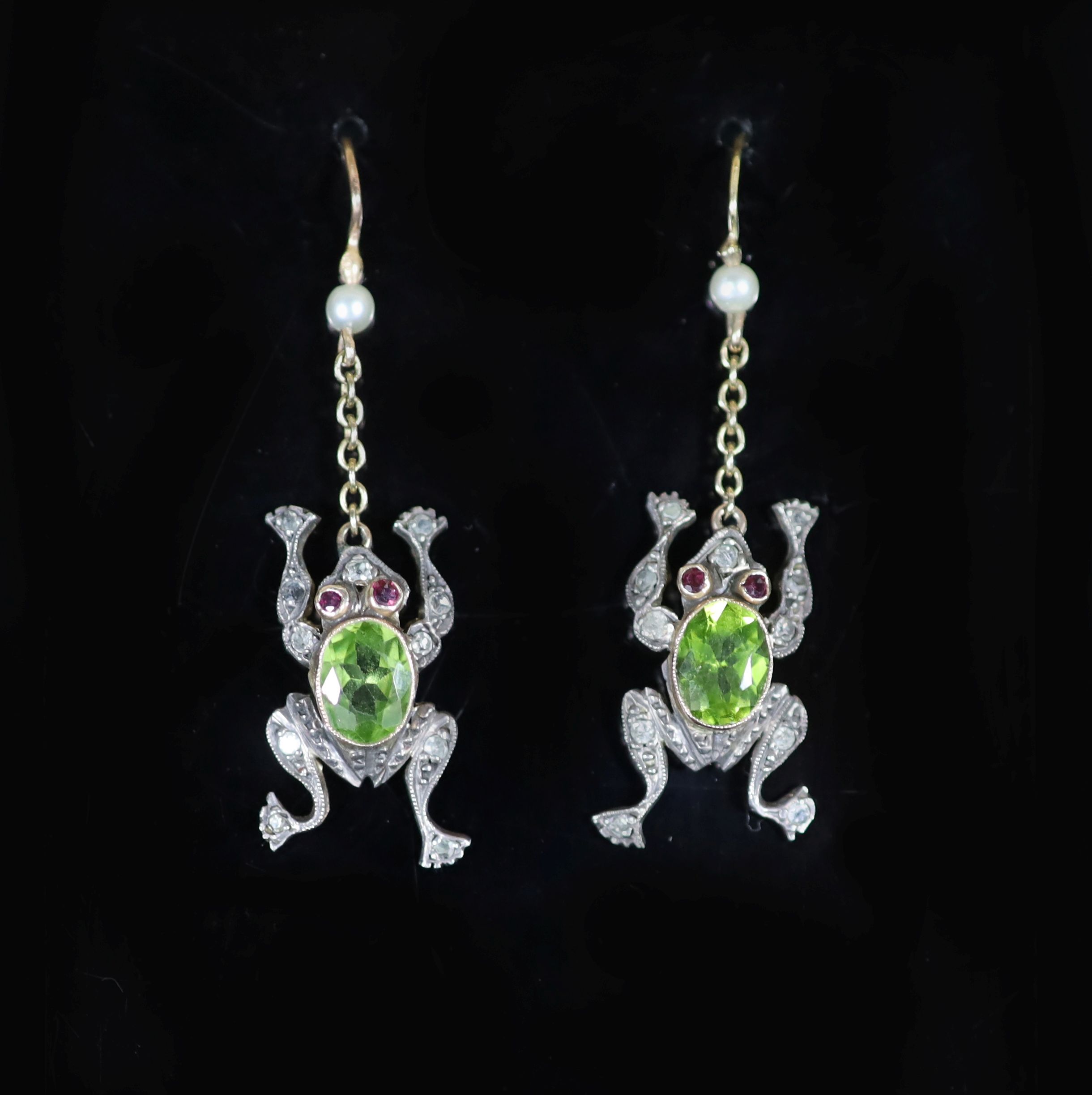 A pair of novelty early to mid 20th century gold, peridot, ruby, diamond and seed pearl set drop earrings, each modelled as a frog